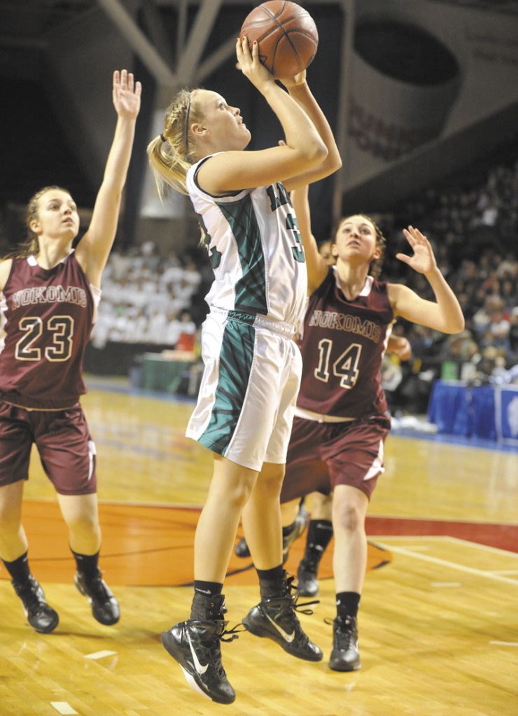 Leavitt's Adrianna Newton pulls up for a jumper in front of Nokomis' Kelsie Richards (23) and Marissa Shaw (14) during the Class B girls basketball state championship game. .