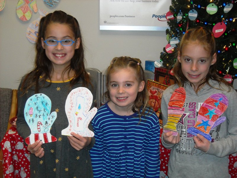 Decorating Mittens to assist the Wells-Ogunquit Community Outreach Program were several Wells Elementary School students. People's United Bank coordinated the effort. From left are siblings Grace, Elizabeth and Hannah Bradish.