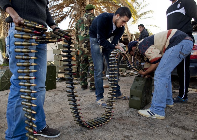 Libyan militia members who are now part of the forces against Libyan leader Moammar Gadhafi organize ammunition in Benghazi, in eastern Libya, on Monday. The uprising has posed the most serious challenge in Gadhafi’s more than four decades in power.