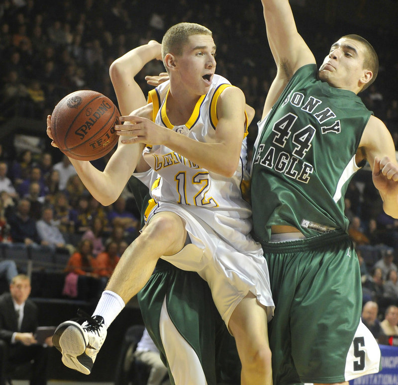James Kapothanasis of Cheverus looks to pass after a baseline drive as Jeff Amell of Bonny Eagle defends Monday night during the Western Class A championship game at the Cumberland County Civic Center. The Stags advanced to the state title game Saturday in Augusta.