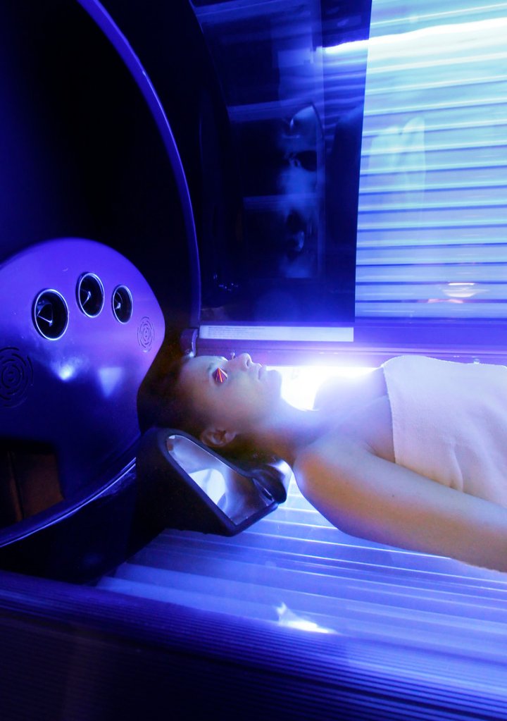 Elise Kennaugh, 25, of Portland uses a tanning bed at Local Acapulco Tanning Salon in South Portland. She started going to tanning salons when she was 16, with her mother's permission.