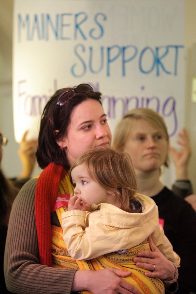 Courtney O’Brien of Bath holds her daughter Josephine O’Brien-Potvin at Tuesday’s news conference.