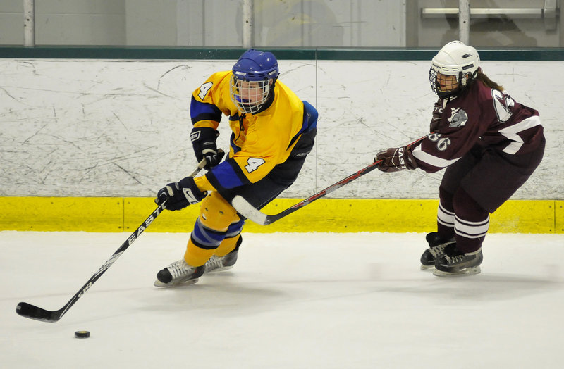 Hugh Grygiel of Falmouth drives with the puck Tuesday night as Kayleigh Trepanier of Noble moves in to defend during their Western Class A quarterfinal at Family Ice in Falmouth. The fourth-seeded Yachtsmen advanced with an 11-0 victory at home.