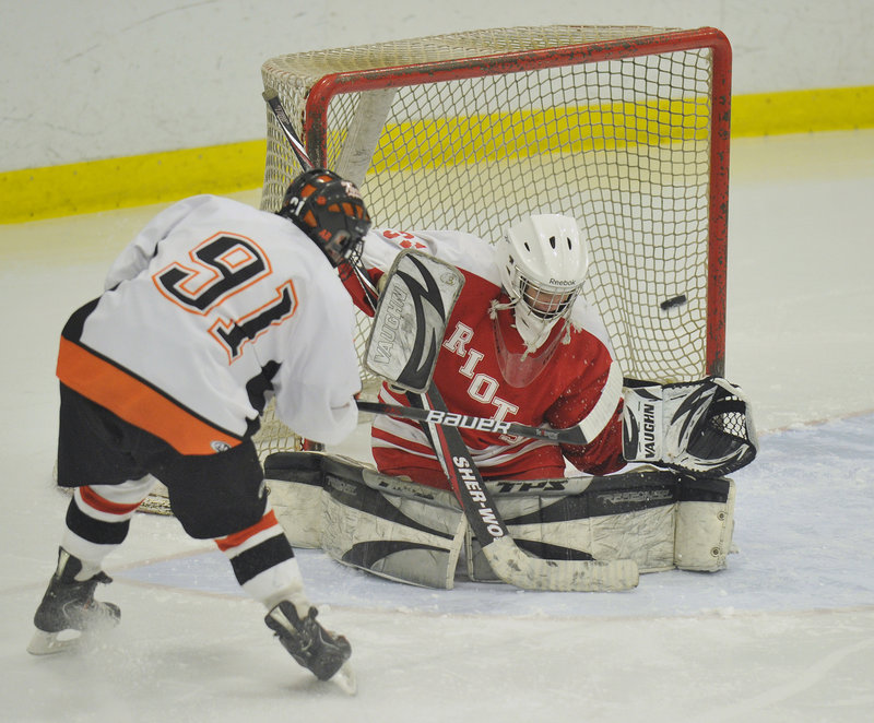 South Portland goalie Dominic Desjardins stonewalls Biddeford's Brady Fleurent for one of his 41 saves Tuesday night in a Western Class A quarterfinal at Biddeford Ice Arena. Fleurent did manage a goal and added four assists as the top-seeded Tigers advanced with a 6-0 victory.