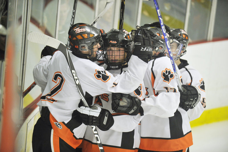 Bryan Dallaire, left, gets congratulations from his Biddeford teammates after scoring one of the Tigers' six goals in a shutout win over South Portland.