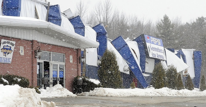 Snow falls on the Kennebec Ice Arena in Hallowell after its roof and upper metal walls collapsed Wednesday. Only three men were inside the structure at the time, and no one was injured. “Thank God it happened when it did,” said Dan Gagnon who said he has played in a men’s hockey league at the arena for about 20 years. “It’s tragic. My kids grew up in this building.”
