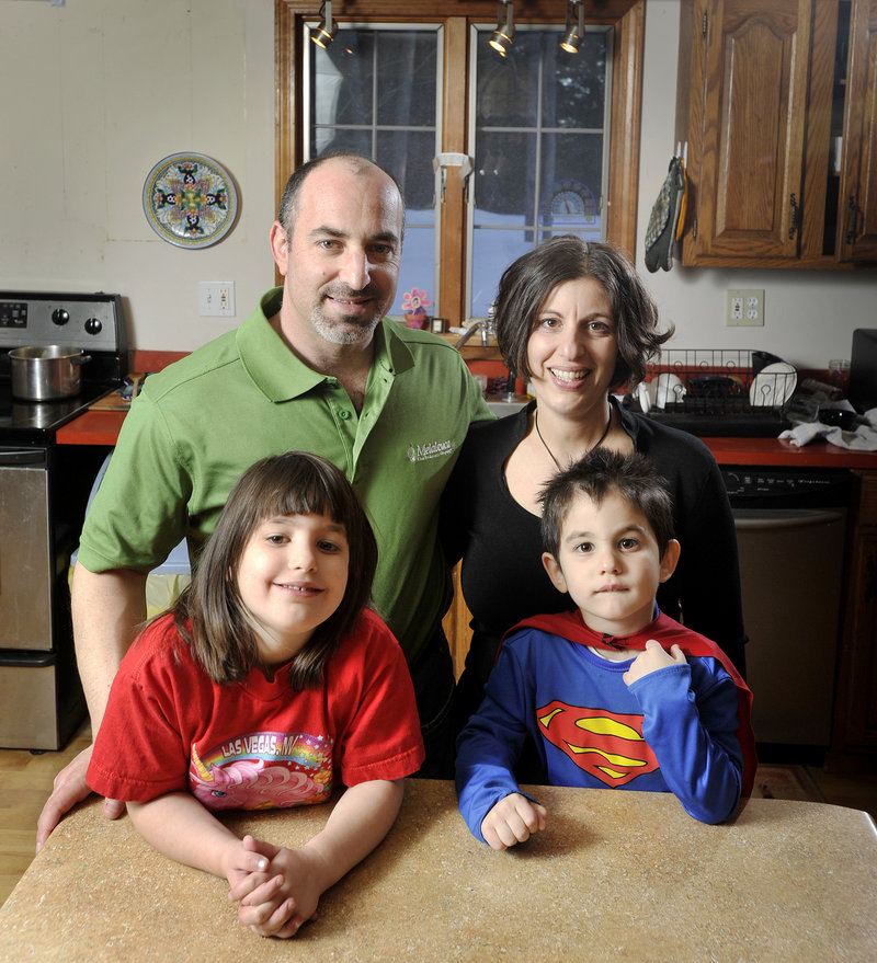 Gregg and Anat Levey, shown with Kaya, 6, and Aden, 4, say their smart meter led to insomnia and dizziness. The Leveys had CMP put the old analog meter back on their house in Falmouth. Meanwhile, company officials and regulators say there is no evidence of adverse effects from the meters' radio waves.