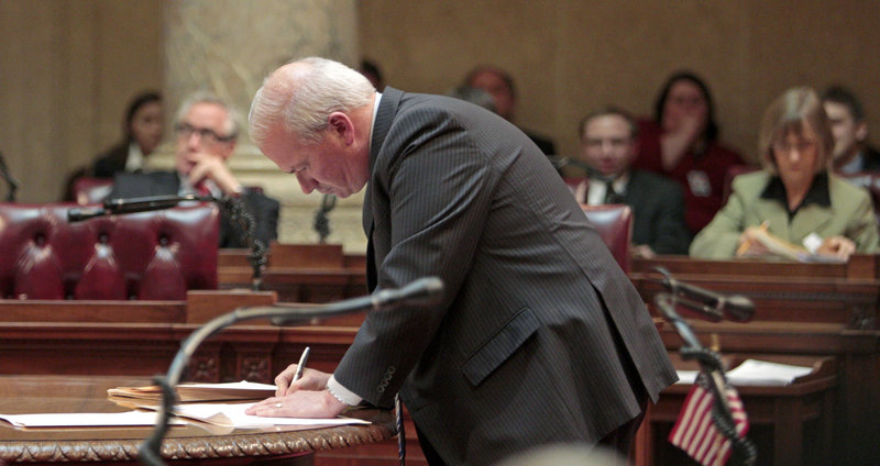 Wisconsin Senate Majority Leader Scott Fitzgerald signs orders finding the 14 missing state Senate Democrats in contempt, at the state Capitol in Madison, Wis., on Thursday. Fitzgerald called on any Wisconsin citizens who see the senators to contact police.