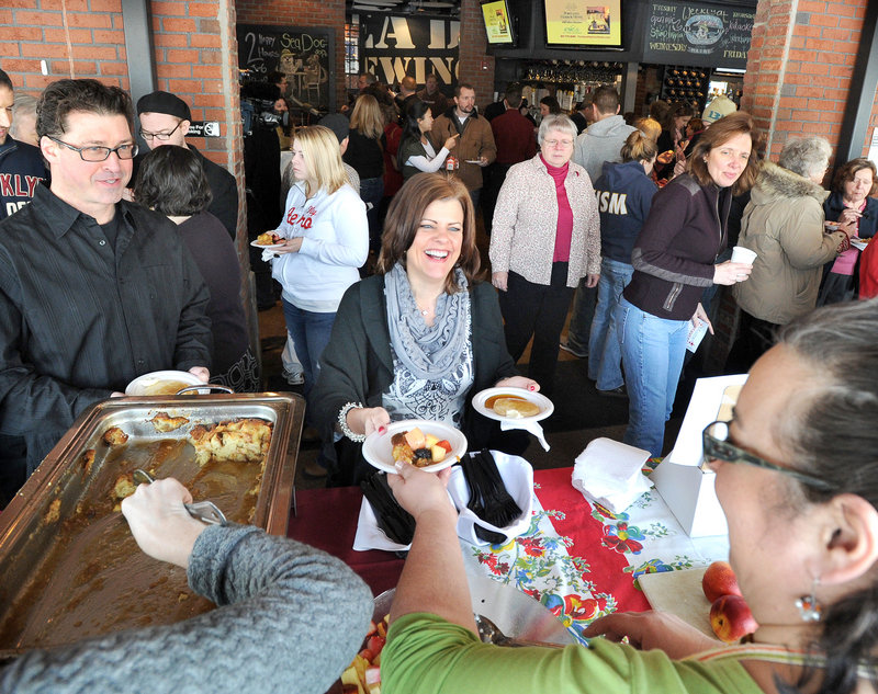 Rebecca Daigle of Portland samples one of the dishes served at the Incredible Breakfast Cook-Off in South Portland, which raised about $3,500 for Preble Street.