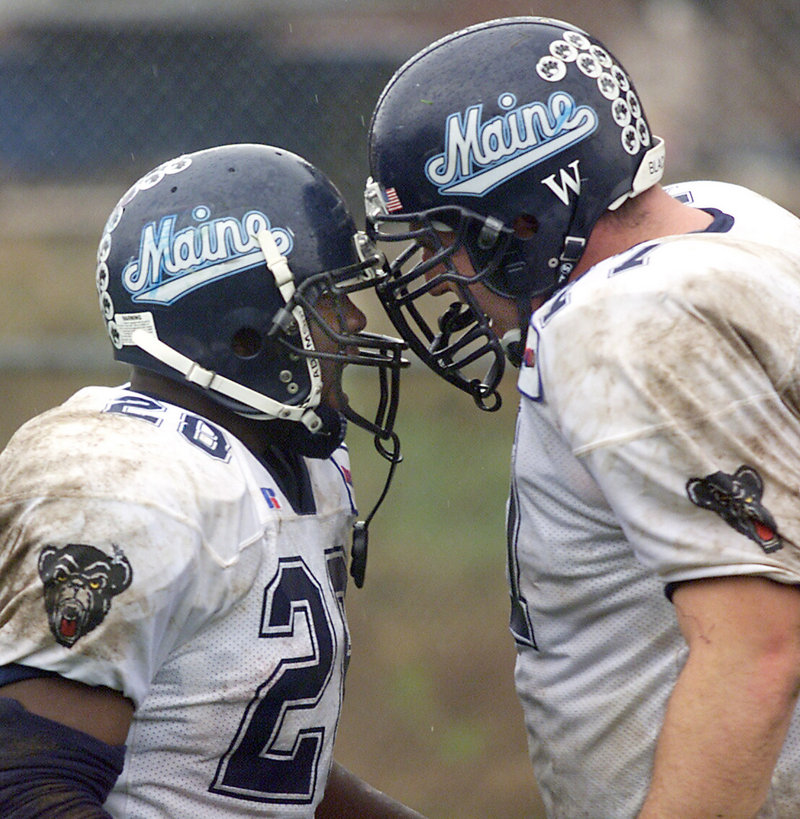 Running back Royston English, left, and offensive tackle Zack Magliaro celebrate during Maine’s memorable 2001 season. Cancer brought them together again in 2009.