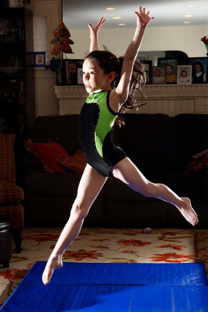 Amalya Knapp, 7, does her gymnastic warm-up exercises at her family’s home in Teaneck, N.J.