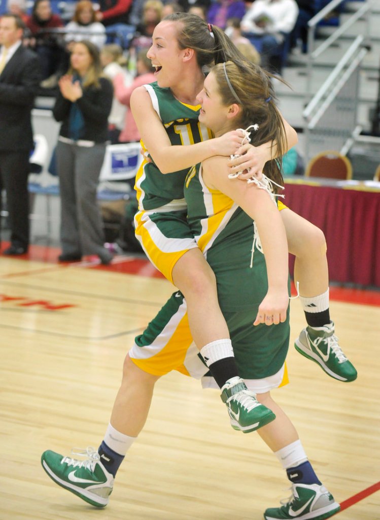 The final buzzer sounds and the excitement begins as Olivia Porch gives Kayla Daigle a lift to join their teammates for the celebration.