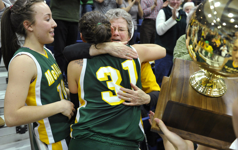 Rebecca Knight shares a hug with longtime McAuley supporter Sister Edward Mary as she and Kayla Daigle take to the stands to celebrate the Lions 39-23 victory over Hampden Academy in the Class A state title game Saturday.