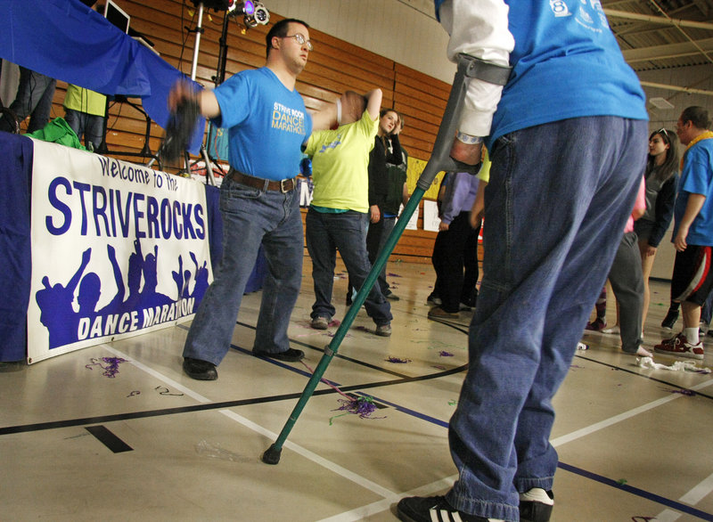 STRIVE member Jon Maniscalco of Gorham, center, and other participants in the 14-hour STRIVE Rocks Dance Marathon move to the final few songs Sunday morning.