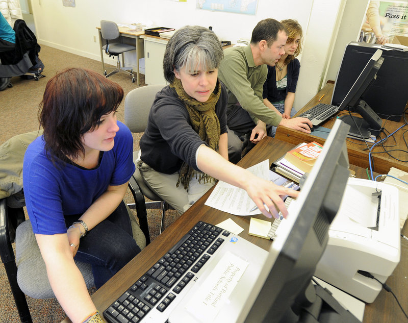 Joline Friedman, center, a teacher at Portland’s Street Academy, helps Ashley Holston work toward a GED certificate. The academy accommodated 233 youths last year, including 35 who earned their GED.
