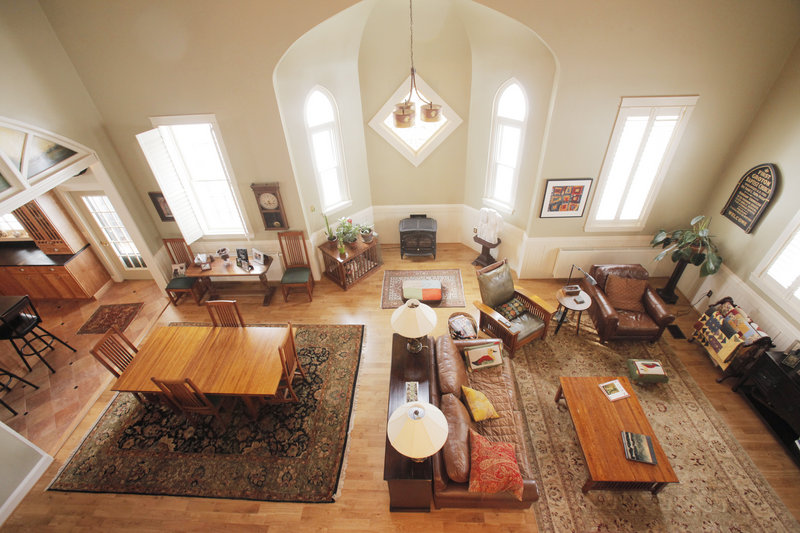 This is the view looking down from a second-floor balcony into the main living area of the home. The ceiling is about 25 feet high; the alcove is where the altar once stood.