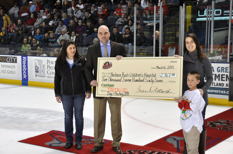 Jim Beaudoin, vice president of sales for the Portland Pirates, presents a check in the amount of $2,767 to the Barbara Bush Children's Hospital at Maine Medical Center after a Day of Hockey on Sunday. The event at the Cumberland County Civic Center featured youth hockey games coordinated by Huskies Youth Hockey, a charity game between Southern Maine Law Enforcement and BIW Ironclad Hockey, and an AHL game between the Pirates and Springfield Falcons. Pictured along with Beaudoin, from left to right, are Beth Brooks of Huskies Youth Hockey community relations, Deirdre Banks of the Barbara Bush Children's Hospital, and Nolan Irish.