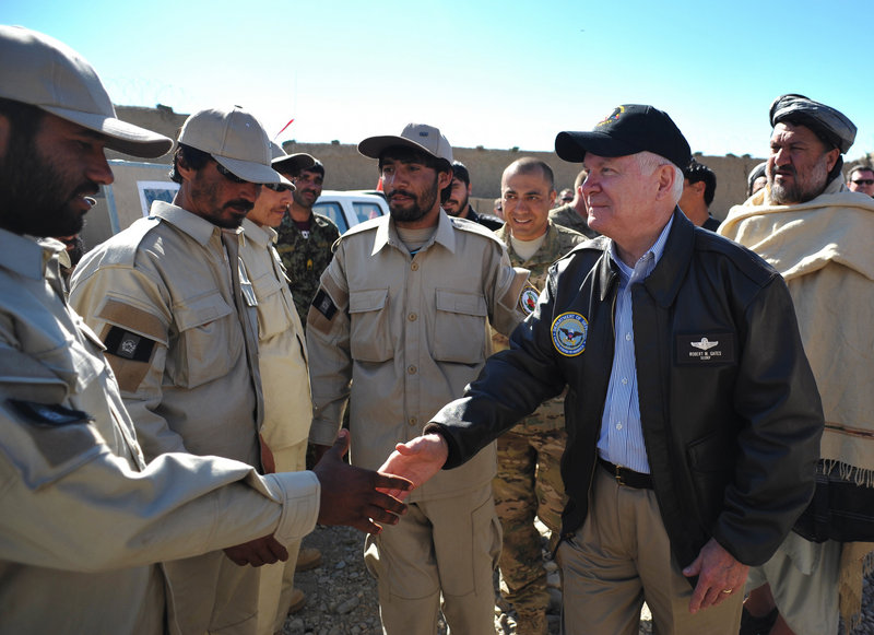 Defense Secretary Robert Gates greets members of the Afghan National Police during a visit to Combat Outpost Kowall in Afghanistan on Tuesday.