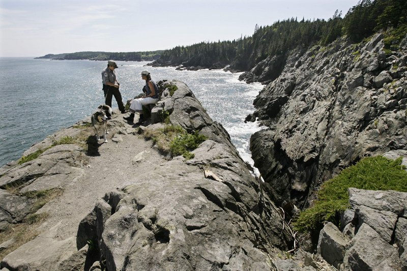 Lindsay McMahon, a ranger for the Maine Bureau of Parks and Lands, left, speaks with trail steward Lynn Bradbury in 2008 in the Cutler Coast Public Reserve, one of the most popular spots on a new map and guide to the state’s public lands.