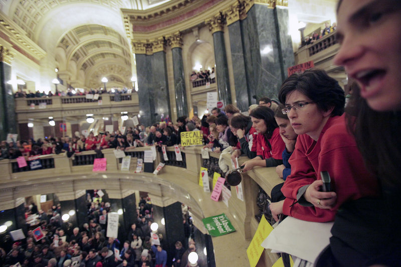 Protesters line the Capitol balcony in Madison, Wis., in this March 9 file photo.