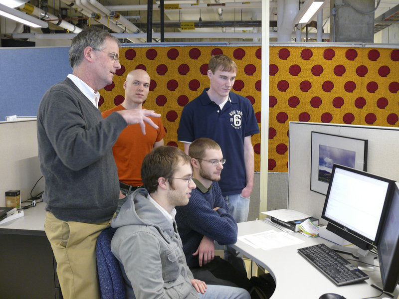 Bruce MacLeod, a computer science professor at USM, works with students on mobile phone health care for the poor of Ghana and Nigeria. From left are MacLeod, Brent Atkinson of Hollis, Matt Blanchette of Scarborough, Brian Hartsock of Oakland and Dave Roberge of Auburn.