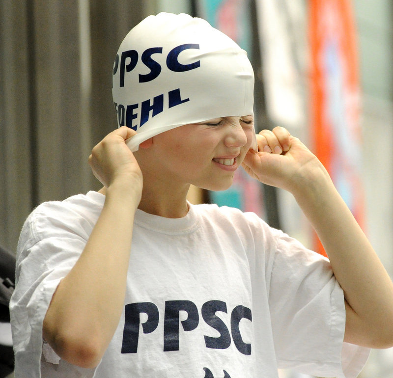 Reed Foehl, 10, of the Portland Porpoises grimaces while adjusting his cap. He finished fifth in the 50 breast stroke.