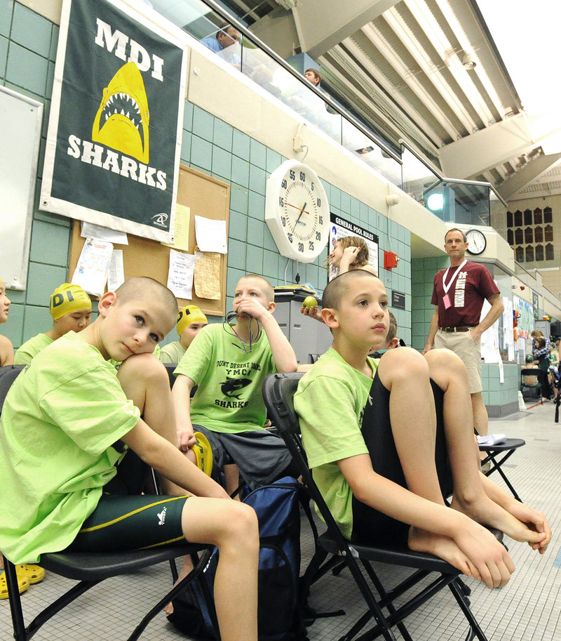 Zeke Valleau, 9, left, and Oliver Johnston, 10, of Mt. Desert Island await their turns Friday during the age-group meet at Bowdoin College. They were part of a winning 400-yard freestyle relay team for boys 10 and under.