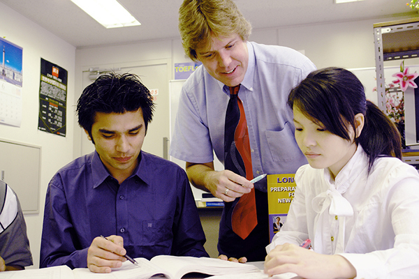 Thom Burns, center, an Old Orchard Beach resident who is currently working as an English teacher at Tokyo English Specialists College in Tokyo, is pictured at the school with students K.C. Rabindra, left, and Chin Shin.