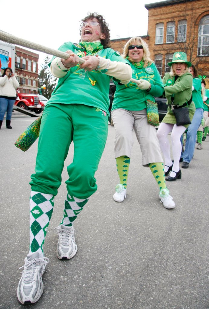 From left, Rose Wood, Lynn Roberts and Sharon Sciretta, all of the Byrnes Irish Pub Pub Scouts Band, brace themselves Saturday while participating in the Bath Blarney Days annual Tug of War following the parade.