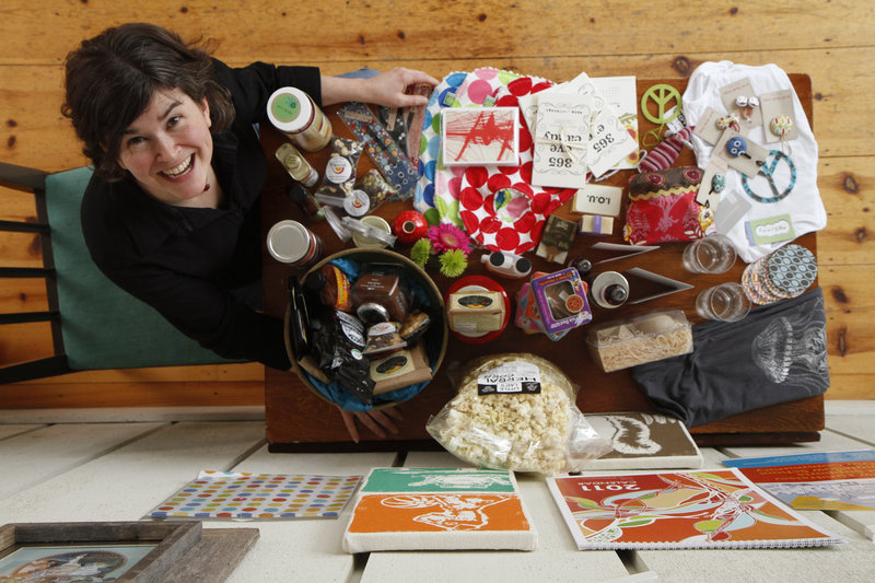 Masey Kaplan shows products from her school fundraising catalog, Close Buy, at her Falmouth home. The catalog features products made by local companies, such as lip balms from Westbrook-based Mad Gab's and handbags from Angela Adams.