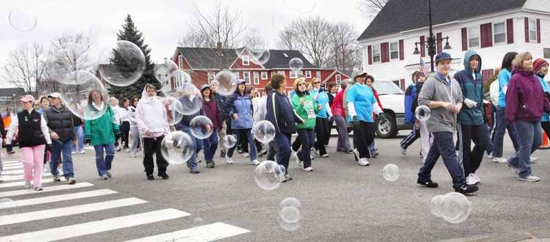Bubbles blow across Main Street in Saco on Sunday as walkers participate in Mary’s Walk to raise money for the Maine Cancer Foundation. The event, which also includes the Kerrymen Pub 5K Road Race for runners, raised $187,660 this year, pushing the 13-year total past $1.6 million.