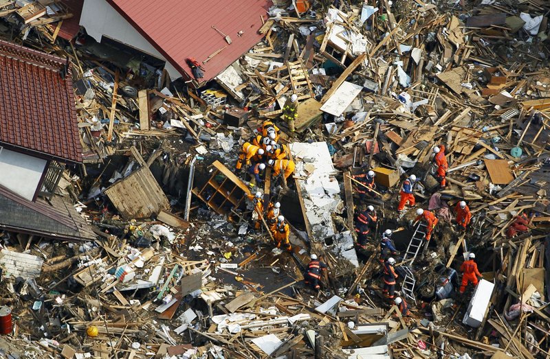 Rescuers search for the victims of Friday’s tsunami at Noda village in northern Japan on Monday, three days after a massive earthquake and the ensuing tsunami hit the country’s east coast. In Miyagi prefecture, about 2,000 bodies were discovered Monday at two sites. More than half a million people have been displaced, and the death toll is widely expected to reach into the tens of thousands.