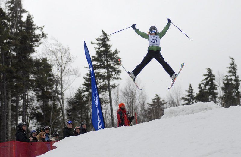 A competitor takes a jump in the Bust and Burn amateur mogul competition during the Parrot Head Festival at Sunday River last year. The ski area’s end-of-season festivities run from April 1 to 3 this year.