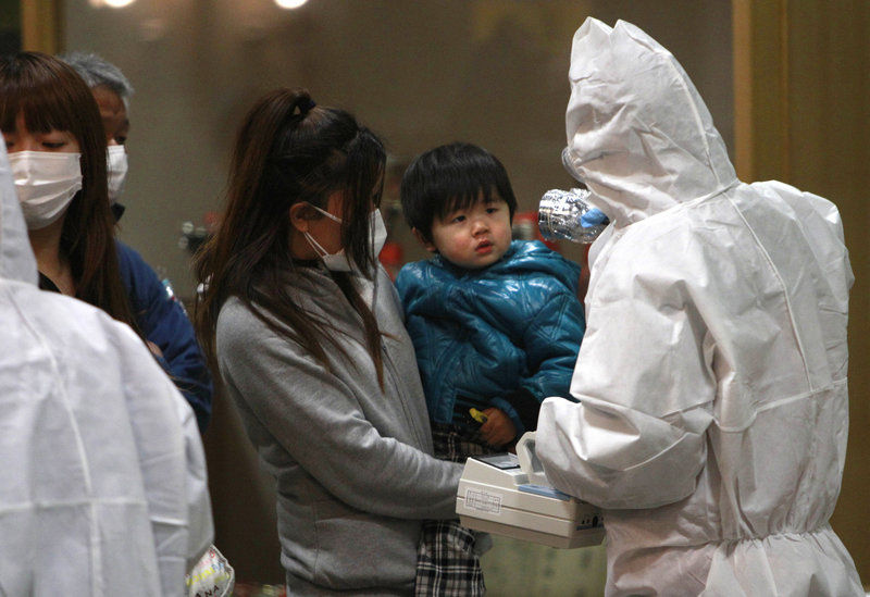 A child is screened for radiation exposure Tuesday at a testing center in Koriyama city, Fukushima prefecture, Japan. The Dai-ichi nuclear power plant on the prefecture’s coast was damaged by explosions and has been leaking radiation for days.