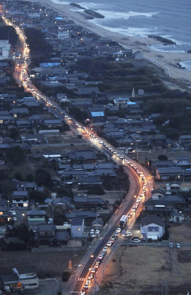 Vehicles driving south out of Fukushima Prefecture, where a troubled nuclear power plant is located, create a miles-long traffic jam in Kitaibaraki, north of Tokyo, on Tuesday.