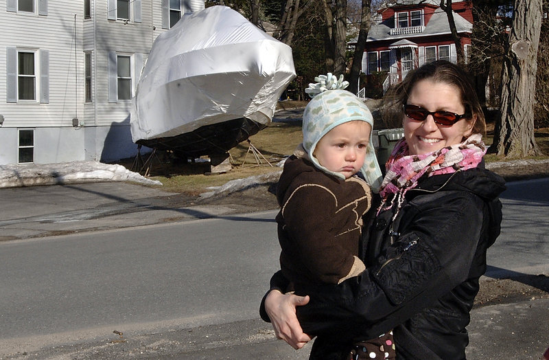Kim Meyers, holding her daughter, Iris, says having boats stored in the neighborhood is a normal part of winter.