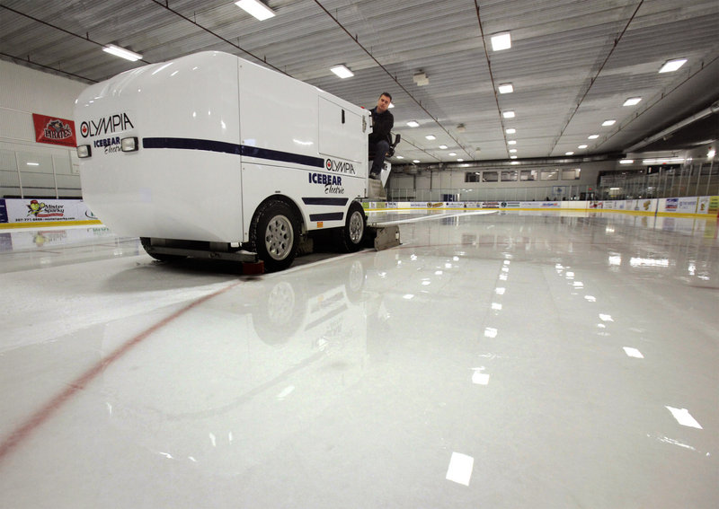 Rob Carrier resurfaces the ice at the Portland Ice Arena using an electric Olympia machine. The electric resurfacer, as opposed to a propane-powered machine, guarantees the absence of fumes that have been harmful to players and customers in other rinks around the country.