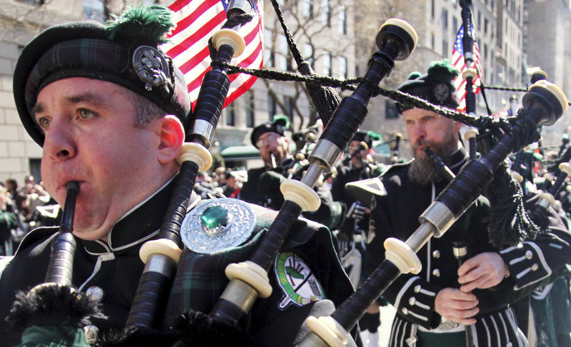 Joseph O’Keefe, left, plays a bagpipe as the Department of Sanitation of New York’s Emerald Society Pipes and Drums marches during the St. Patrick’s Day parade a year ago in New York. St. Patrick’s Day is taking on added meaning this year, as Irish-Americans have a long history of involvement in the labor movement.