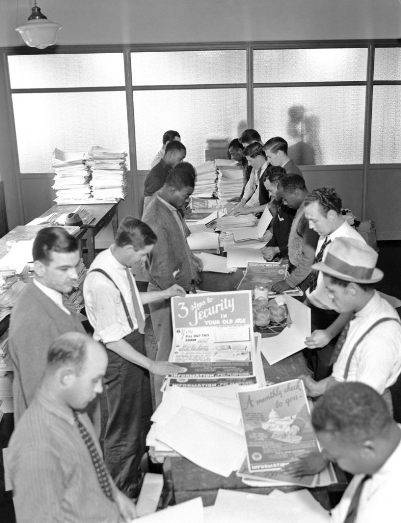 Social Security workers prepare posters for distribution in this undated photo.