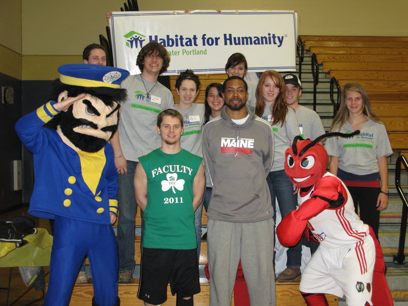 A group of students from Providence College in Rhode Island spent some time in Greater Portland working for Habitat for Humanity as part of an alternative spring break. In the front row are, from left, Yachty, the Falmouth High School mascot; Trevor Paul, a faculty member and event founder; Antonio Anderson, a player for the Maine Red Claws, and Crusher, Red Claws mascot. The Providence College students are in the second row.