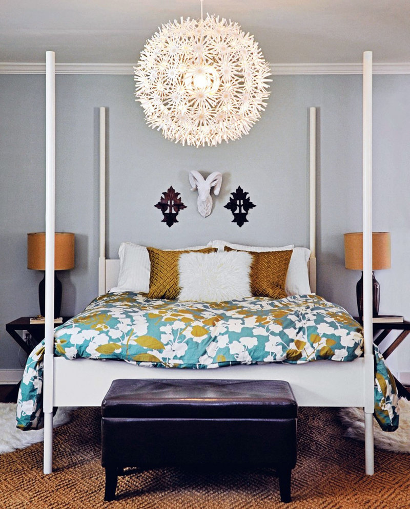 An Ikea bed and light fixture take center stage in the master bedroom at the Petersiks’ house. West Elm bedding, a Pottery Barn area rug (both bought on sale) and Target side tables round out the space.
