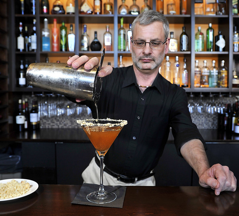 Bar manager Steve Lovenguth at Walter’s in Portland pours his Mark of the Maple cocktail.