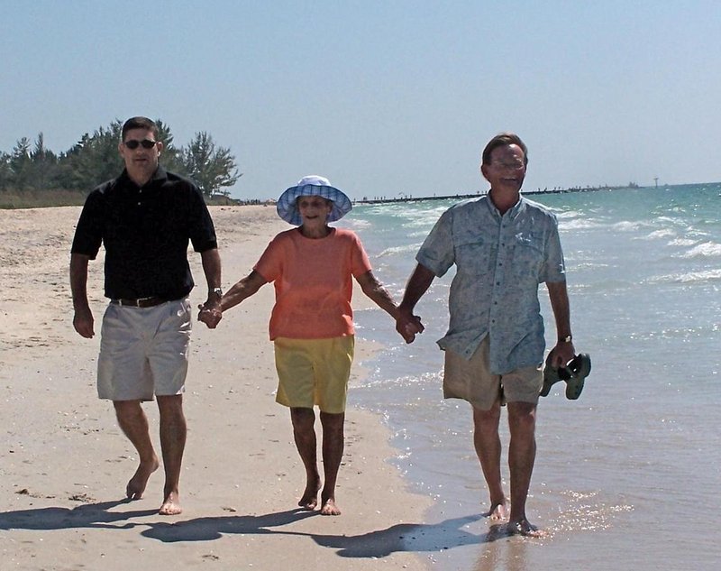 John Noble, III, right, walks the beach in Venice. Fla. in 2009 with his brother Tallison and his mother, Barbara.