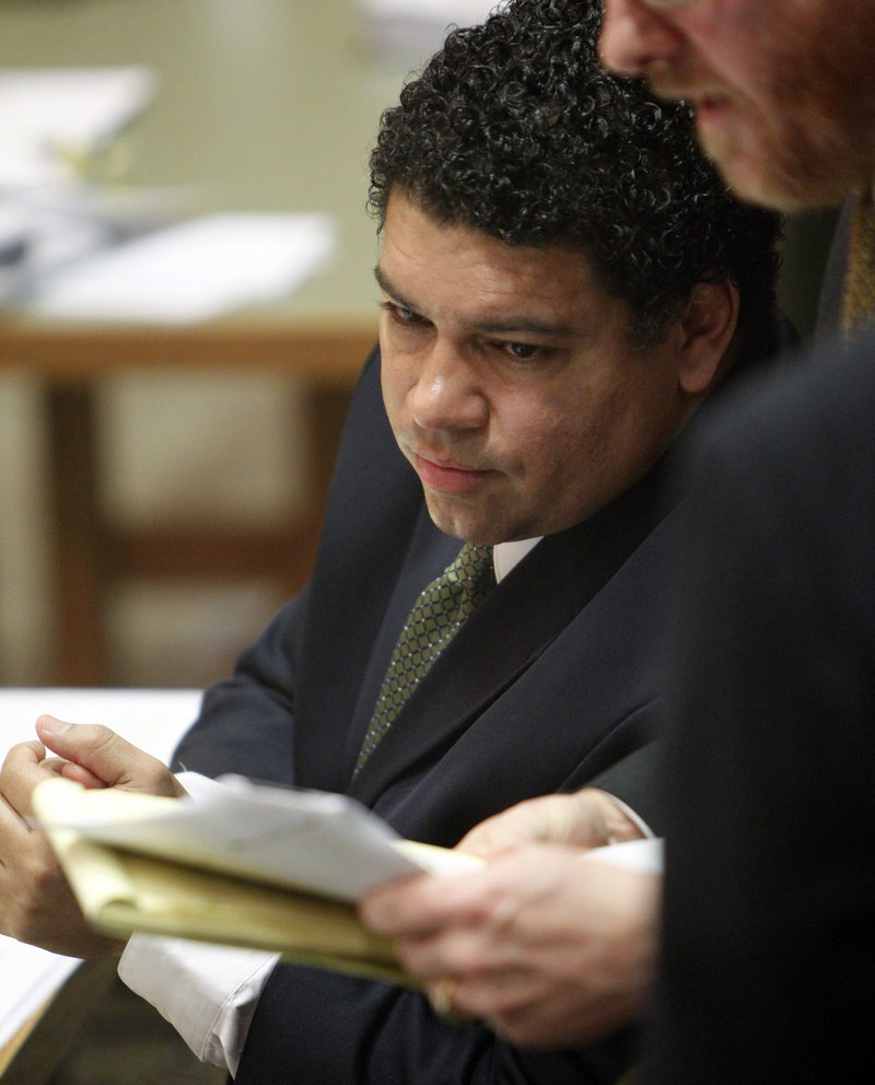 Dane County District Attorney Ismael Ozanne consults with a colleague during a hearing in Madison, Wis., on Friday. A judge ruled in his favor in a lawsuit alleging that GOP lawmakers violated an open meetings law before the Senate passed a bill curtailing union rights.