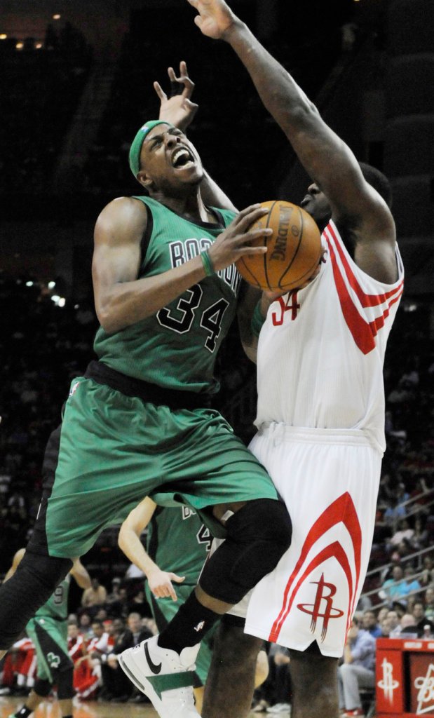 Paul Pierce of the Celtics drives into Patrick Patterson of the Rockets on Friday. Pierce was held to 10 points.