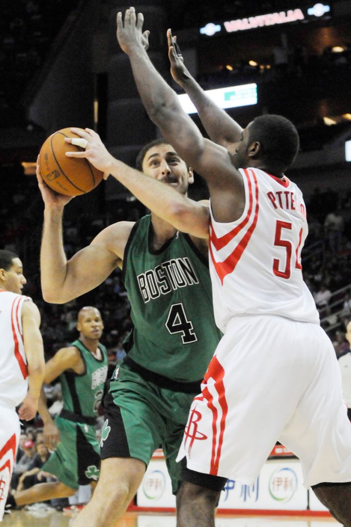 Nenad Krstic of the Boston Celtics looks for a way around Patrick Patterson of Houston. The Celtics lost, 93-77.