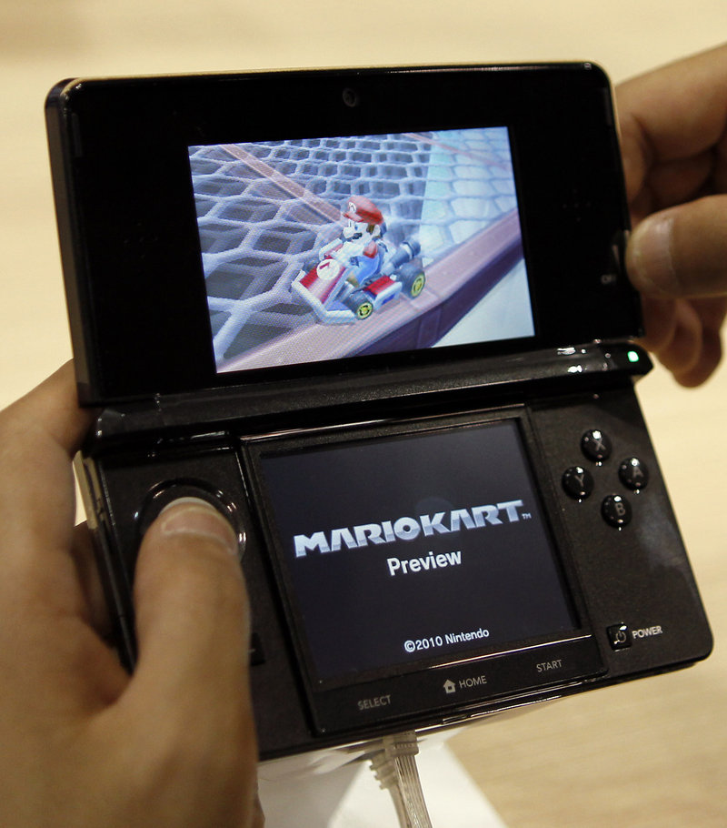 A visitor operates a Nintendo 3DS featuring 3-D imagery. Nintendo Corp. has warned that the 3-D screen on its new 3DS handheld game device shouldn't be used by children 6 or younger because it may harm their immature vision. Optometrists say there's no danger to vision and the device could find undiagnosed problems.