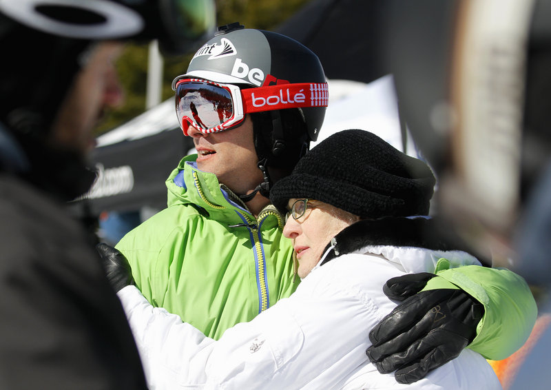 Seth Wescott keeps an eye on the competition Saturday at the Sugarloaf Banked Slalom while spending time with his mother, Margaret Gould Wescott.