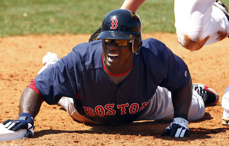 Boston outfielder Mike Cameron dives back to first base in the sixth inning of Saturday’s spring-training game against the Pittsburgh Pirates in Bradenton, Fla. Pittsburgh won 7-5. Red Sox starter Josh Beckett took the loss.