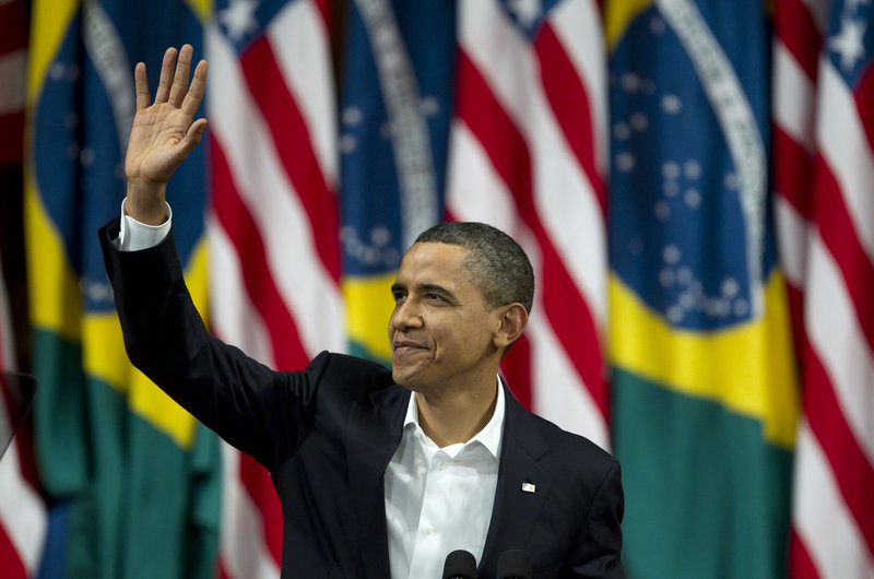 President Obama waves before giving a speech at the Municipal Theater in Rio de Janeiro, Brazil, on Sunday. He praised Brazil for moving millions into its middle class and embracing human rights, underlining that point as unrest sweeps the Middle East and north Africa.